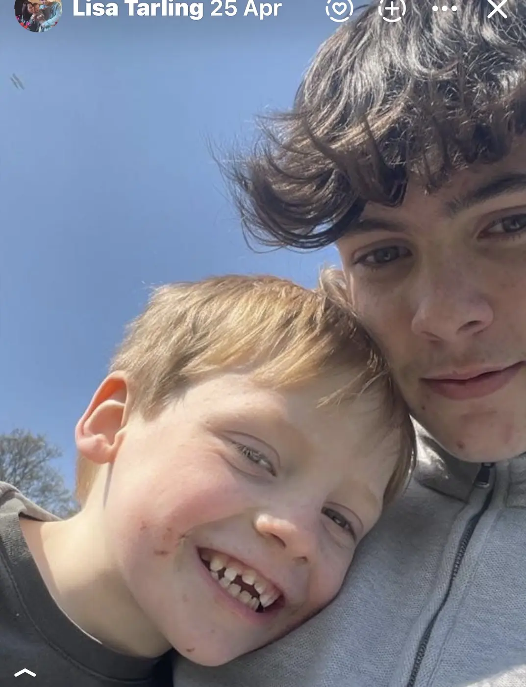 Phoenix smiling with his younger brother